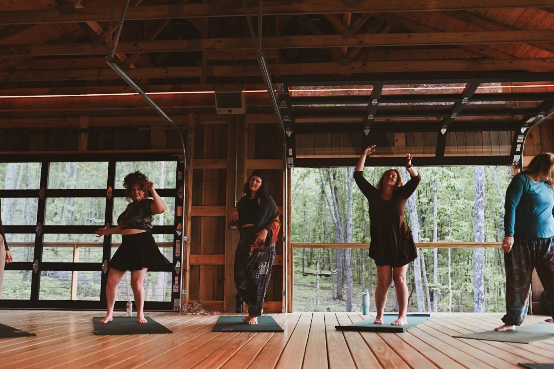Women dancing barefoot in the open barn