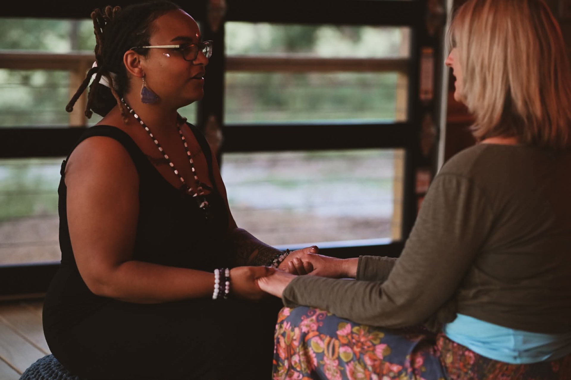 Two women holding hands in conversation